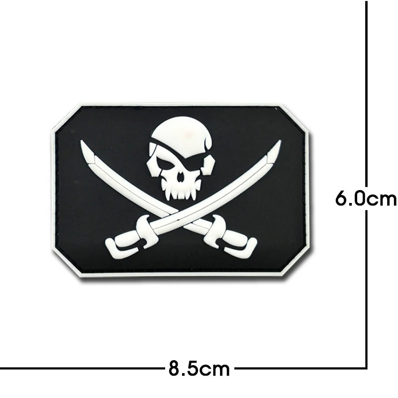 A black embroidered patch featuring a white skull and crossed swords with reflective accents.