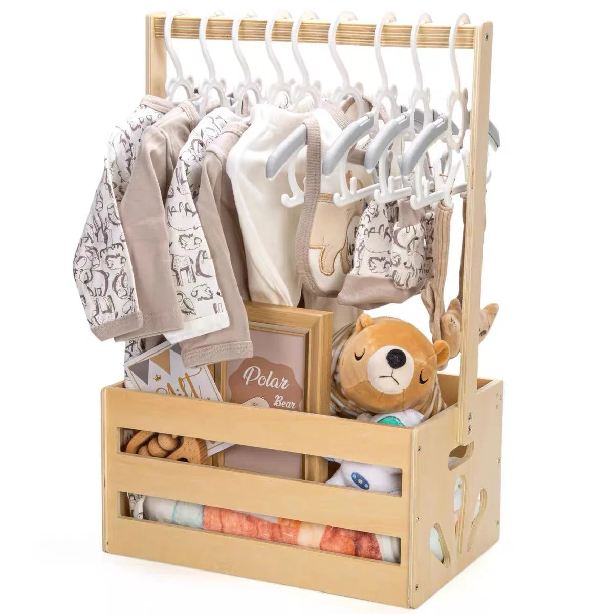 Wooden storage crate with a long handle holding baby clothing and toys.