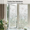 Decorative window film casting a rainbow effect on a sunny day through a glass door.