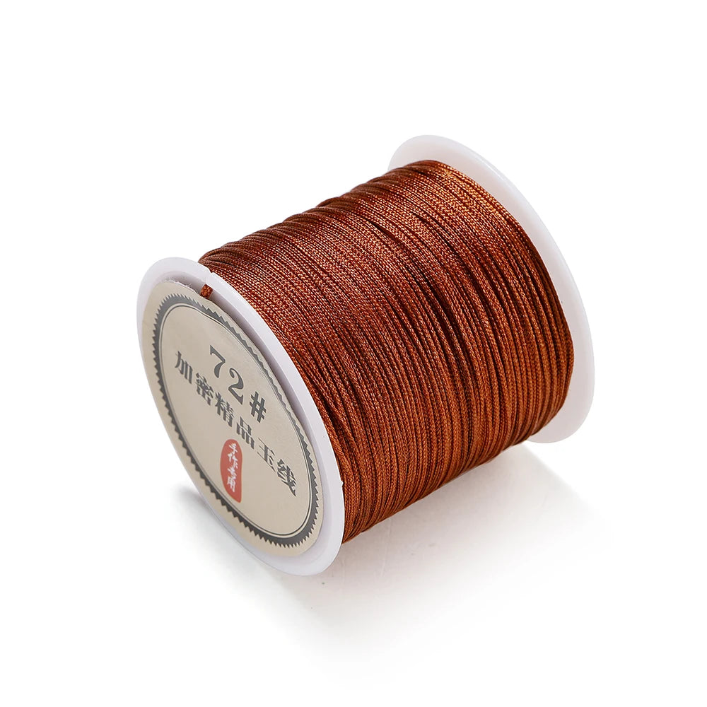 A spool of 0.8mm brown nylon macramé cord for jewelry making with a white plastic core.