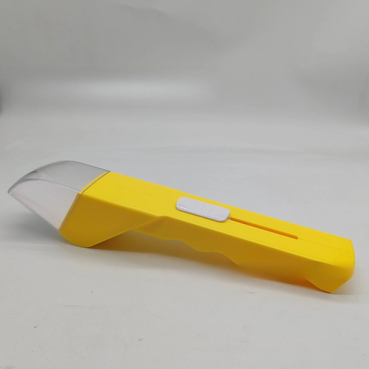 A yellow handheld insect catcher with a clear plastic head and white grip is shown on a white background.