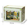 A wooden dollhouse miniature assembly kit featuring a garden scene with LED lighting and floral decorations.