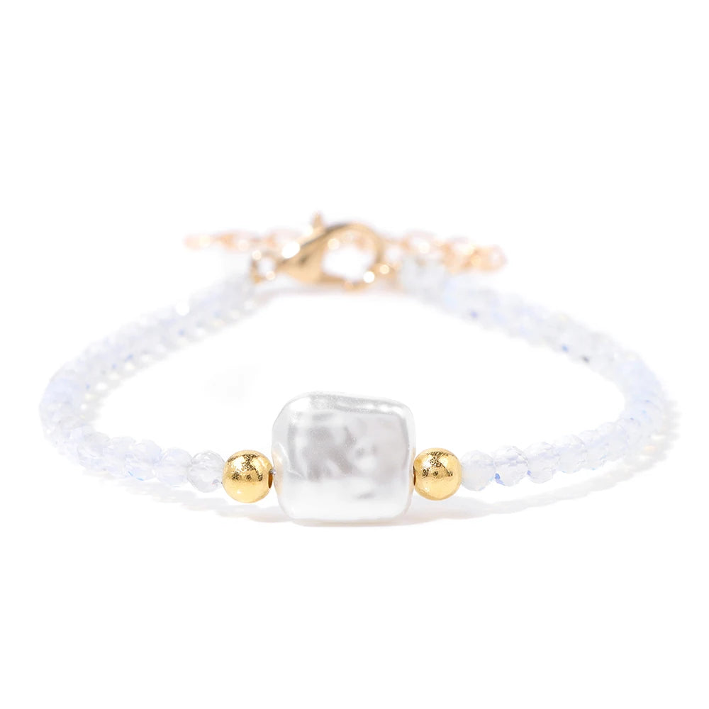 A white natural stone bead bracelet with small purple accents and a gold lace-up closure.