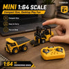 A yellow 1:64 scale RC engineering series forklift with a trailer and a remote control in a close-up shot.