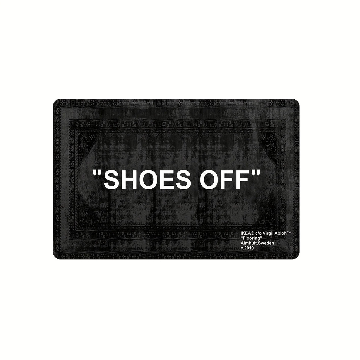 A black minimalist doormat with the text SHOES OFF engraved on it.