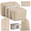 A set of beige travel packing cubes and storage organizer bags for packing and organization.