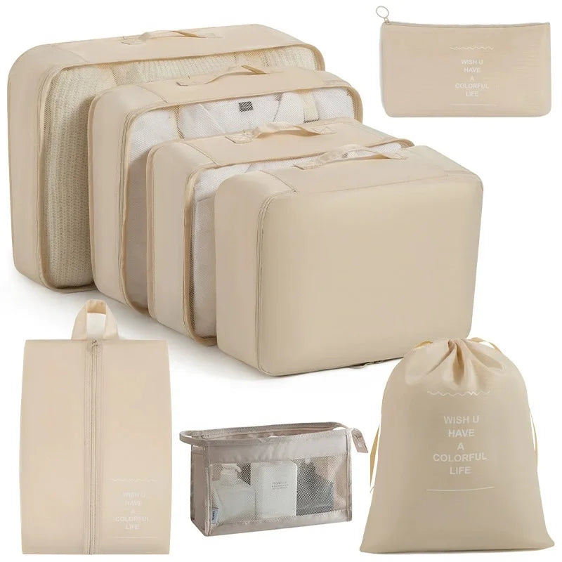 A set of beige travel packing cubes and storage organizer bags for packing and organization.