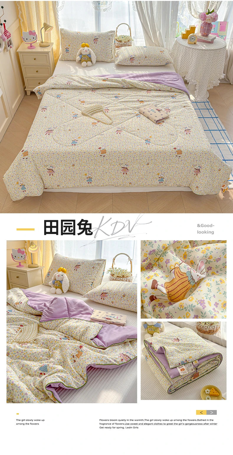 A light yellow and white quilt featuring a playful cartoon print of animals and flowers on a bed.