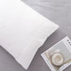 A white microfiber pillowcase is shown on a gray fabric background.