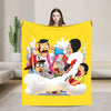 A yellow throw blanket featuring a cartoon illustration of characters in clouds.