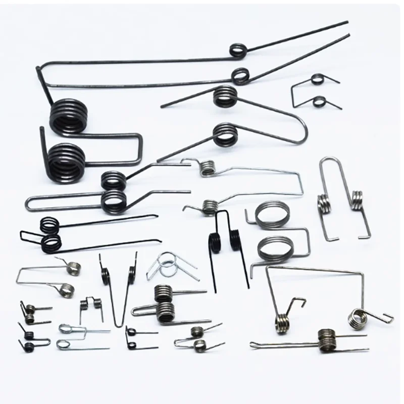 A collection of black metal double torsion springs for DIY projects and repairs