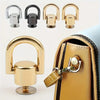 A set of gold and silver metal hardware for a bag or phone case, including clasps and screws.