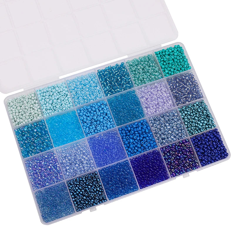 A plastic storage box filled with various colors of glass rice beads for jewelry making