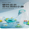 A blue elephant water spray bath toy is shown spraying water in a bathtub.