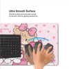 A pink kawaii cartoon gaming desk mat featuring a cute character and a black gaming mouse.