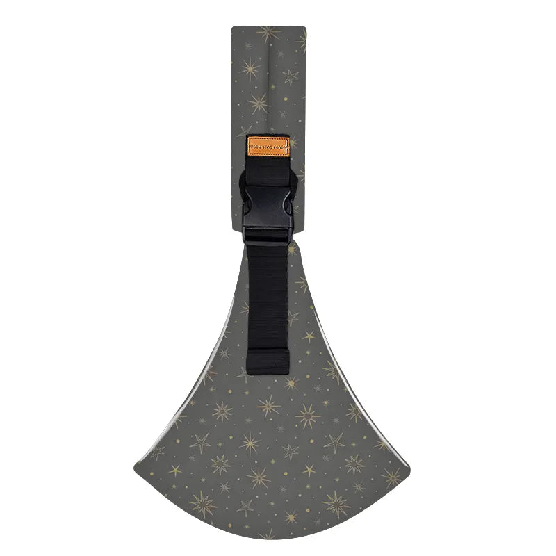 A beige ergonomic baby sling carrier with a black strap and a patterned fabric seat.