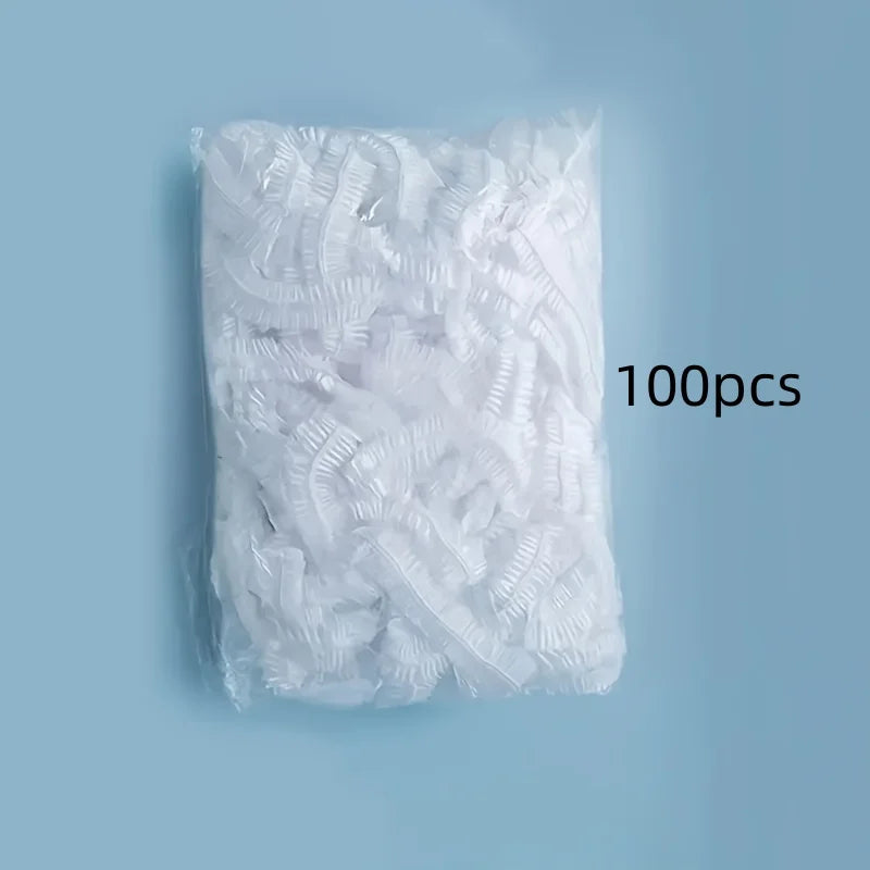 A white plastic bag filled with 100 disposable shower caps for hair protection