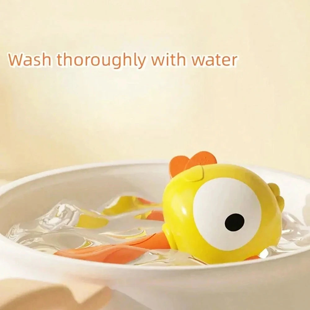 A yellow cartoon animal baby rattle floating in water, with text instructing to wash thoroughly.