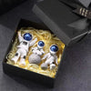 A black box contains three handcrafted astronaut figurine resin spaceman desk decor figures.