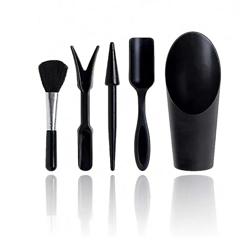 A set of black succulent and bonsai gardening tools including a brush, tweezers, and a spoon.