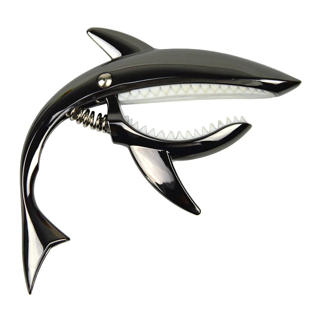 A black pro-grade zinc alloy guitar capo with a light-colored pickguard and a silver tuning peg.