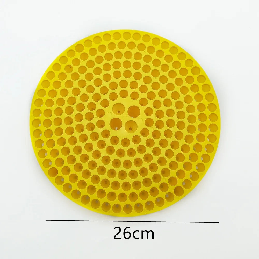 Yellow circular insert for a car wash bucket, featuring a grid of small holes and larger openings.
