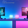 A setup showing a computer monitor and two glowing RGB night lights on a table, demonstrating the Dynamic RGB Mode.