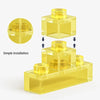 A set of luminous yellow astronaut moon micro building blocks with an LED light, shown in various assembled forms.