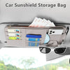 A beige car sunshield storage bag organized with various cards and a smartphone inside.