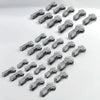 A collection of small, silver-colored quick solderless wire tap connectors arranged in a diagonal line.
