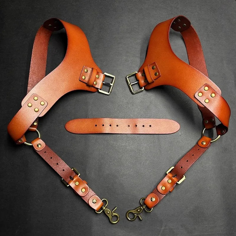 A pair of genuine brown leather double shoulder suspenders with brass buckles displayed against a dark background.