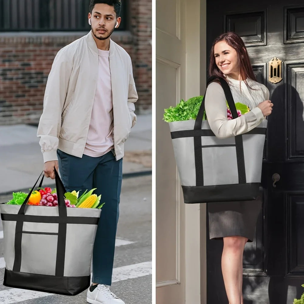 A woman carrying a large gray insulated cooler bag with black straps and a white sweater in front of a dark door.