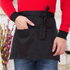 A black half apron with pockets is shown being worn by a person, featuring a red long-sleeved shirt.