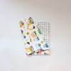 A white soft cotton baby pillowcase featuring a colorful cartoon design of various construction vehicles.