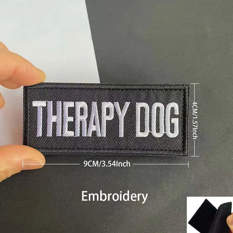 Black embroidered patch with white text Therapy Dog and reflective details