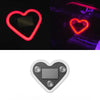 A heart-shaped LED light fixture, glowing red, is shown in various contexts including a close-up and inside a car.