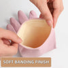 A hand is opening a pink reusable non-slip dishwashing rubber glove to show the soft banding finish.