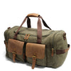 Olive green canvas duffel bag with brown leather pockets and straps