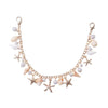 A delicate gold chain accessory featuring starfish and pearl beads.