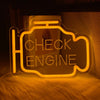 An oil change neon sign with the text CHECK THE ENGINE glowing orange on a dark background.