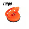 An orange heavy-duty suction cup dent puller tool for car body repair.