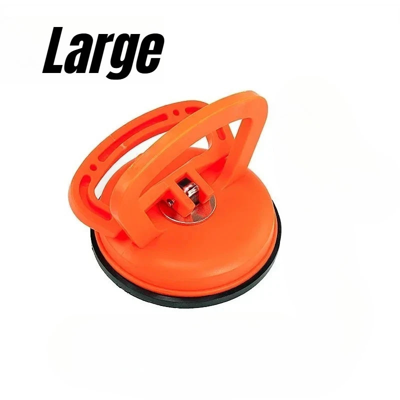 An orange heavy-duty suction cup dent puller tool for car body repair.