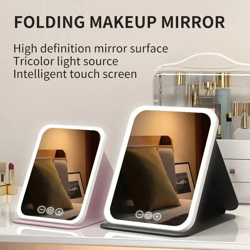 A folding makeup mirror with an intelligent touch screen and multicolor LED light source displayed on a white surface.