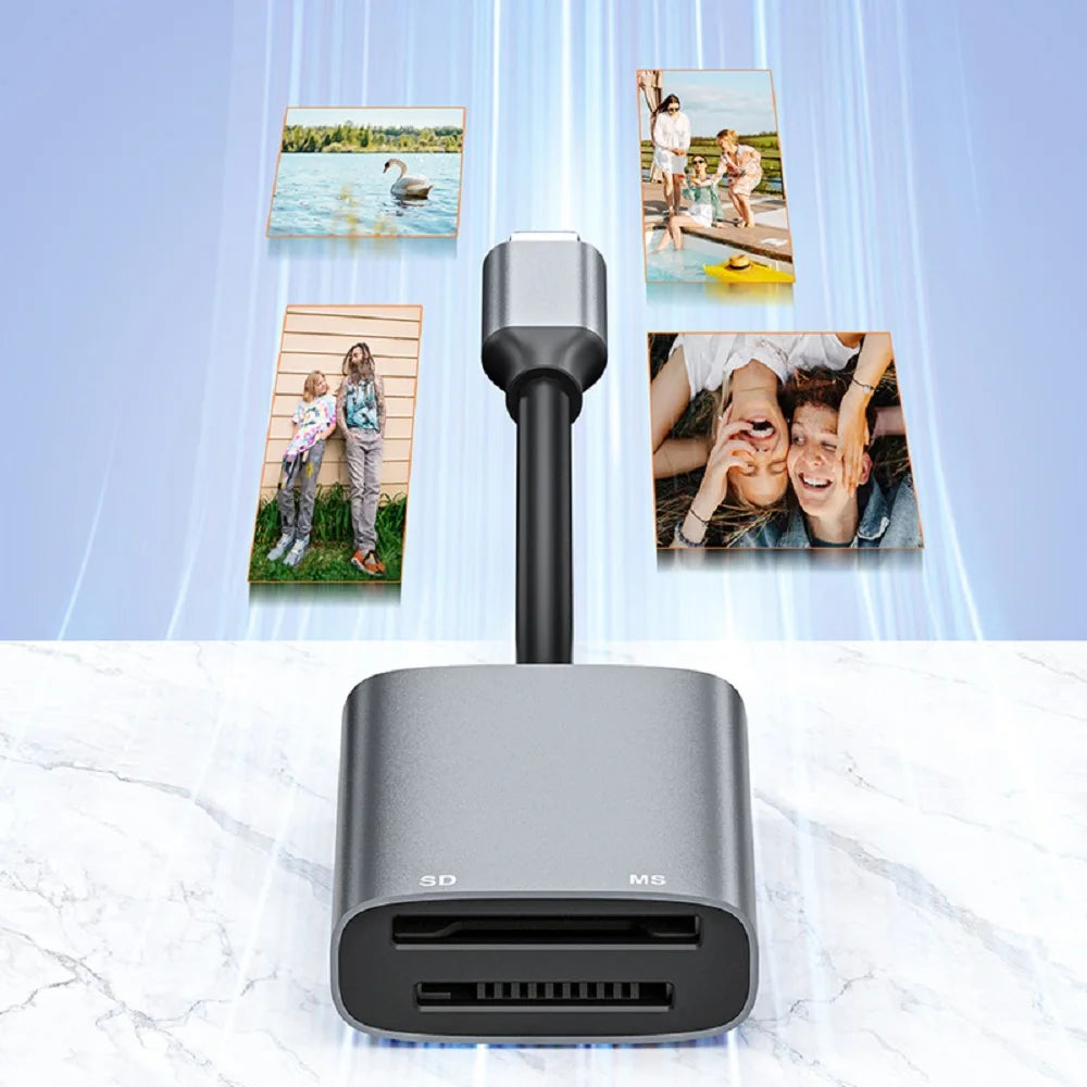 A silver dual-slot card reader with a black cable and several photo cards displayed above it.
