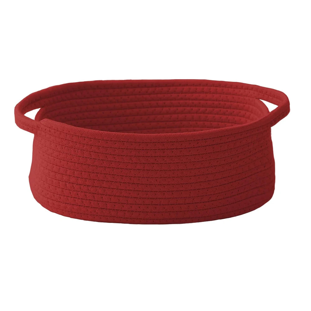 A deep red handwoven rope storage basket with handles.