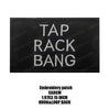 Black embroidered patch with white text that reads TAP RACK BANG