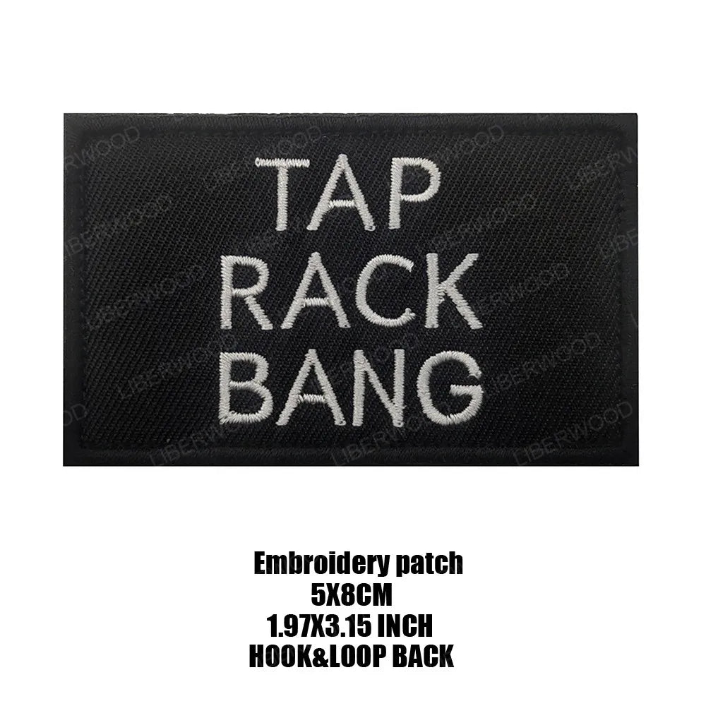 Black embroidered patch with white text that reads TAP RACK BANG