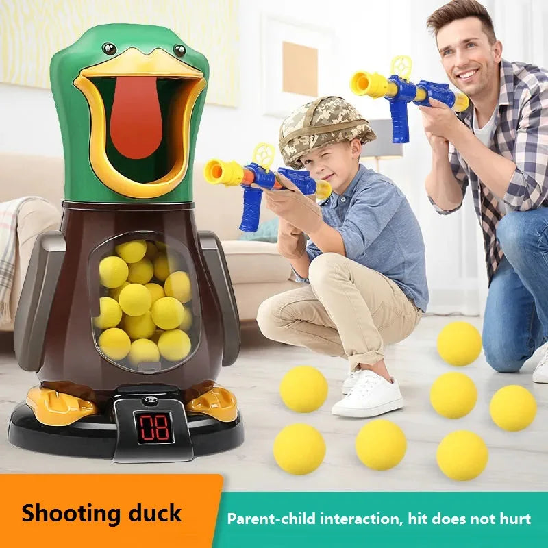 A boy is aiming a yellow dart gun at a green duck shooting target game with an adult.