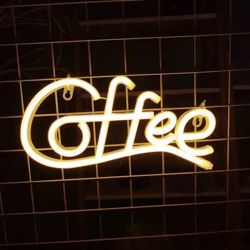 A glowing neon sign spelling out Coffee in cursive script mounted on a dark grid background.