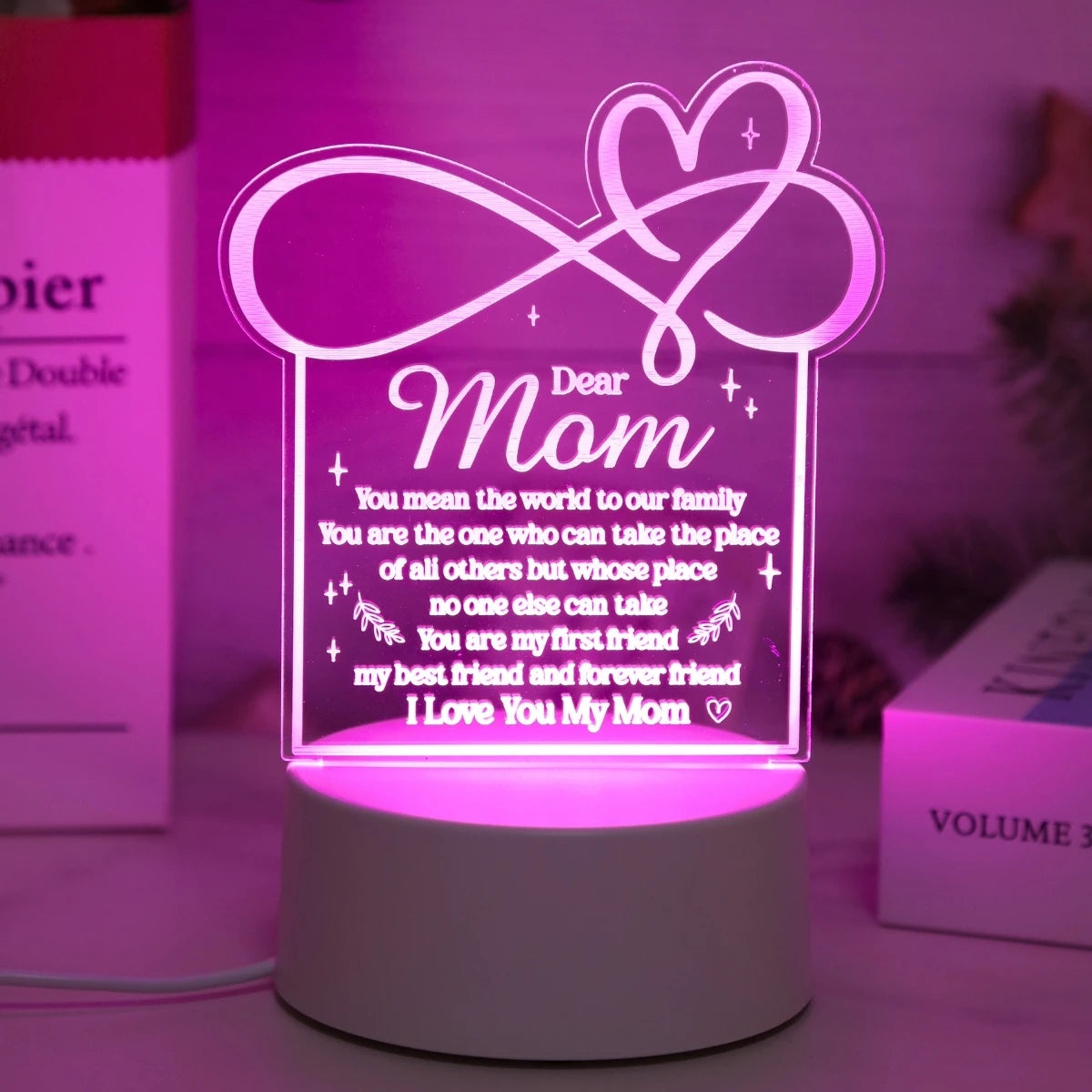A glowing pink heart design on a white base, featuring text that says Dear Mom and expresses love.